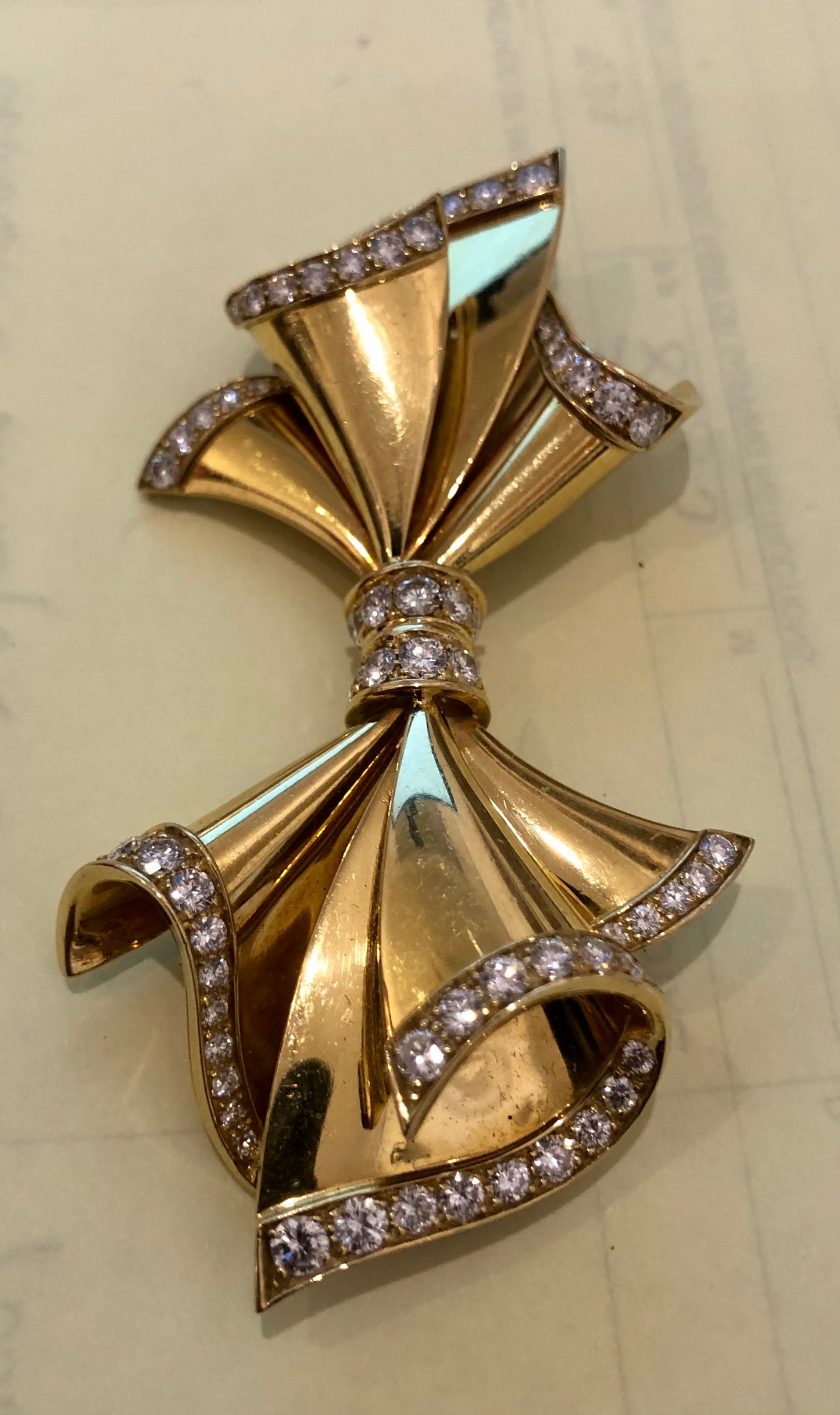 Adler Fine Jewellery. Gold and diamond bow brooch.