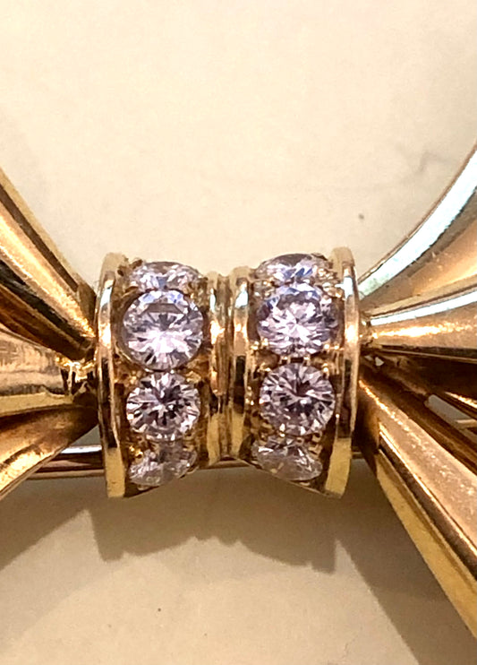 Adler Fine Jewellery. Gold and diamond bow brooch.